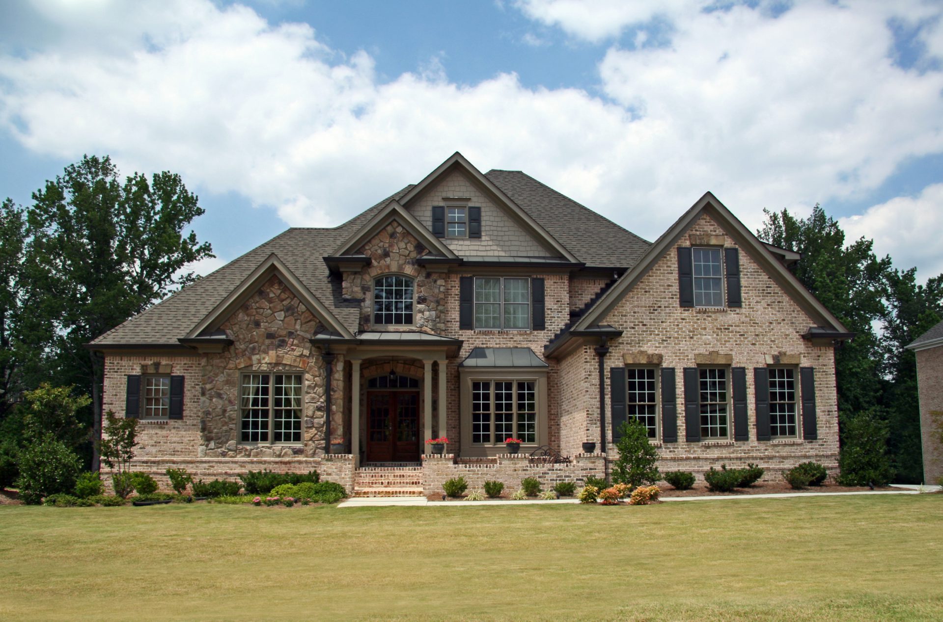 Upper class luxury home with intricate stonework and brick